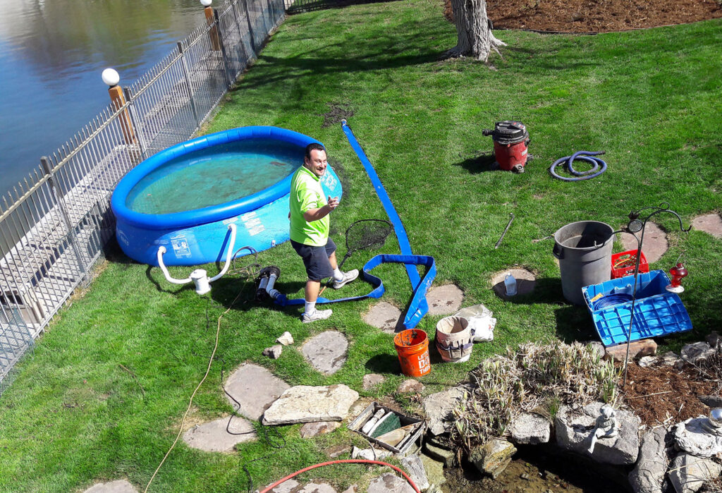Living Waters crews set up a pool for the pet koi as they perform a yearly pond cleaning.